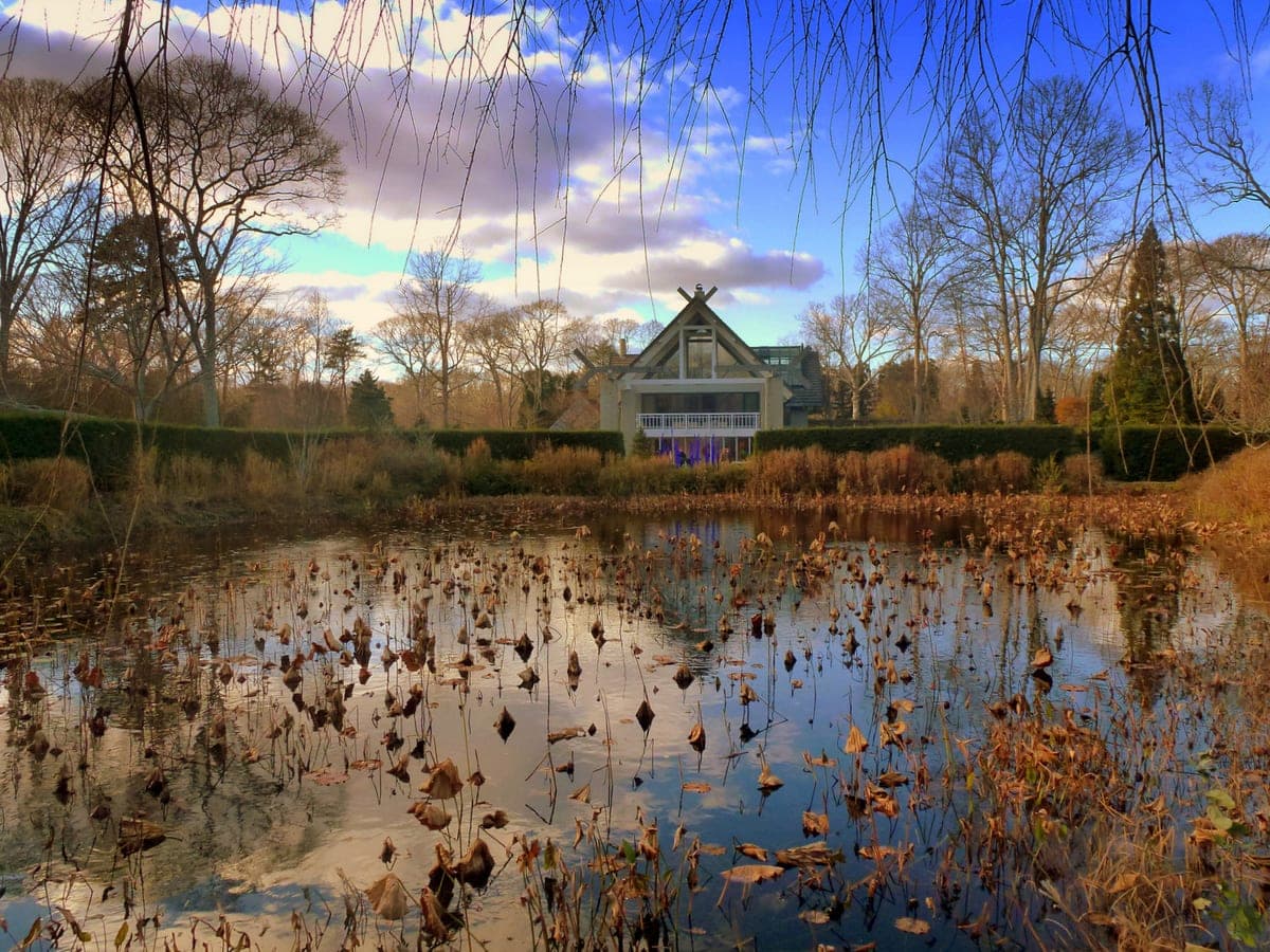 LongHouse Reserve in East Hampton, New York — Jack Lenor Larsen's house across the lily pond, its crossed roof finials modelled on the Ise Shrine.