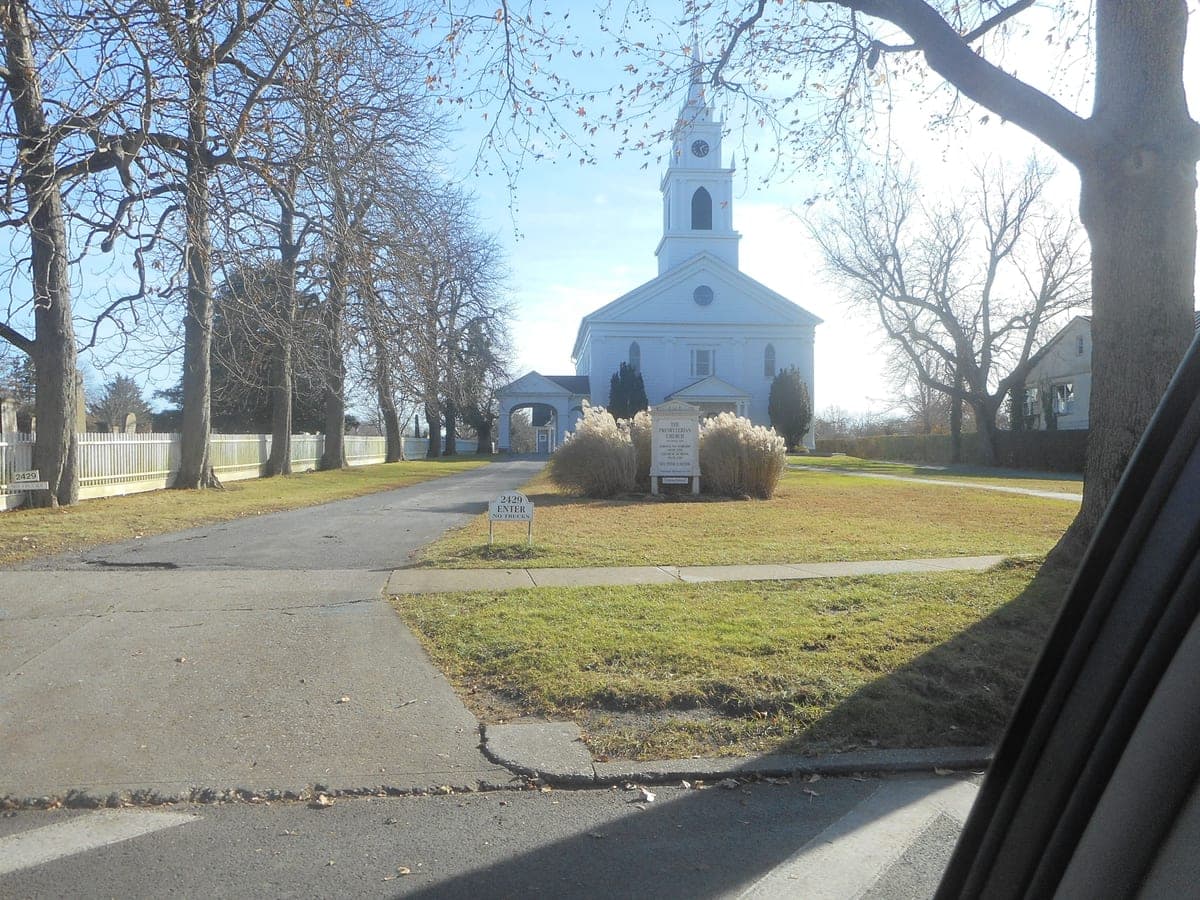 A roadside sign in frame reads "2429", the exact street number of this record's address; the Commons description names the same church on Montauk Highway, Bridgehampton.