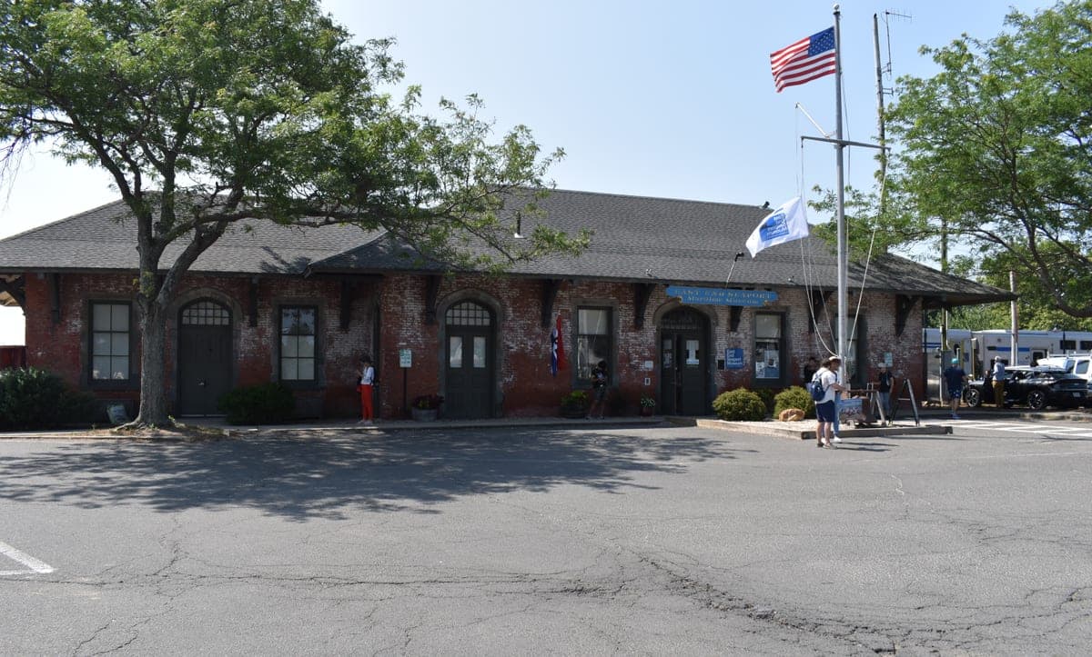 The museum's own wall sign, legible in frame, reads "East End Seaport Maritime Museum"; the Commons description confirms the building is the former LIRR Greenport station.