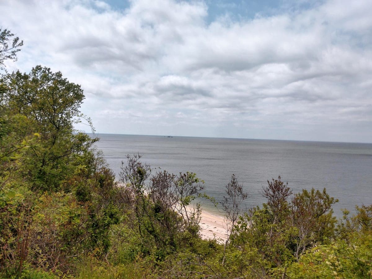 The view from the bluff heights at Hallock State Park Preserve, looking north across Long Island Sound to the Connecticut shore, with the beach below.